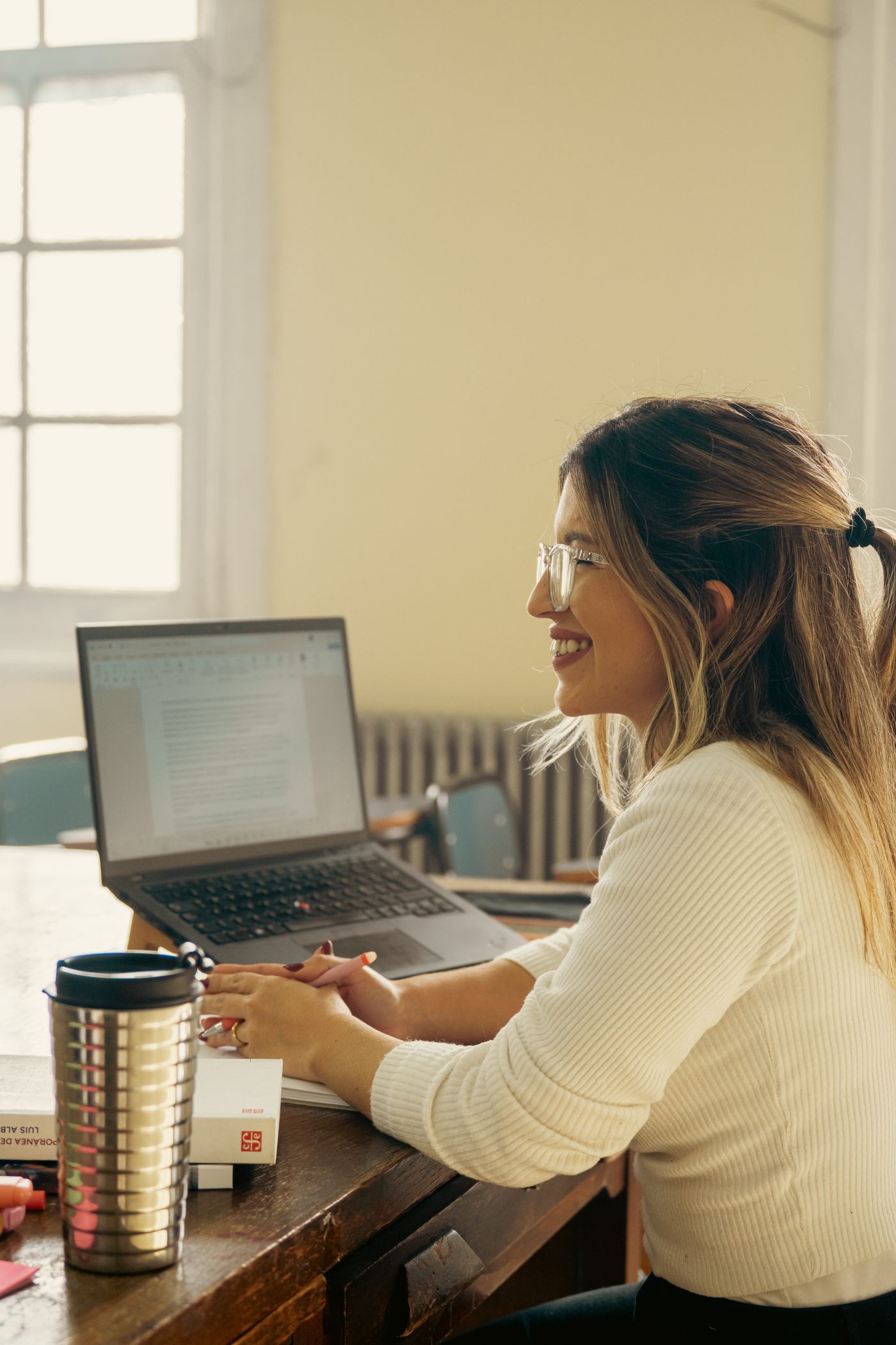 An online teacher smiling while teaching a 1:1 class